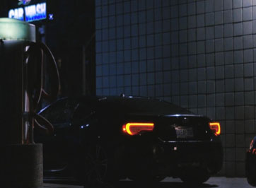 a black car sitting at a carwash